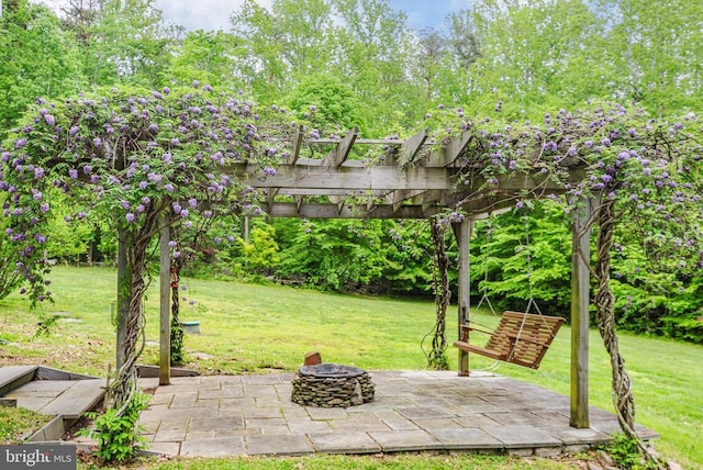  - view of green lawn with a pergola, a fire pit, and a patio area