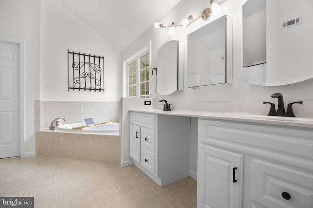  - bathroom with double vanity, a garden tub, tile patterned flooring, and lofted ceiling