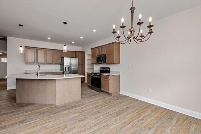 LOT154 Langley Dr, Waynesboro, VA 22980 - kitchen with stainless steel appliances, light wood finished floors, recessed lighting, decorative light fixtures, and a kitchen island with sink