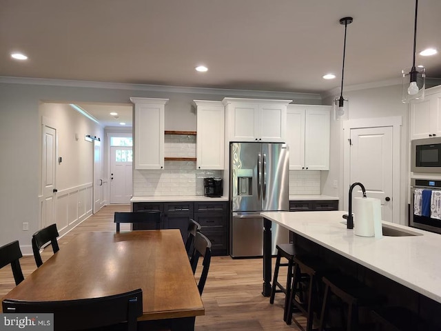 150 Winchester Trl, Mineral, VA 23117 - kitchen with stainless steel appliances, crown molding, white cabinetry, recessed lighting, and light countertops