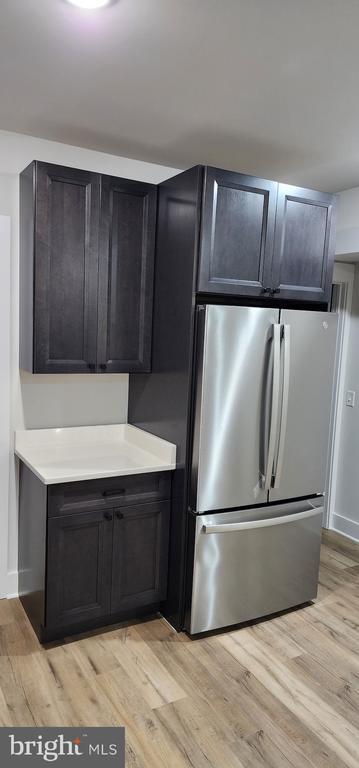 150 Winchester Trl, Mineral, VA 23117 - kitchen with freestanding refrigerator, light wood-style flooring, and light countertops