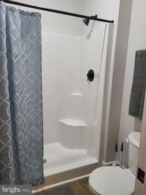 150 Winchester Trl, Mineral, VA 23117 - full bathroom with a shower with shower curtain and wood finished floors