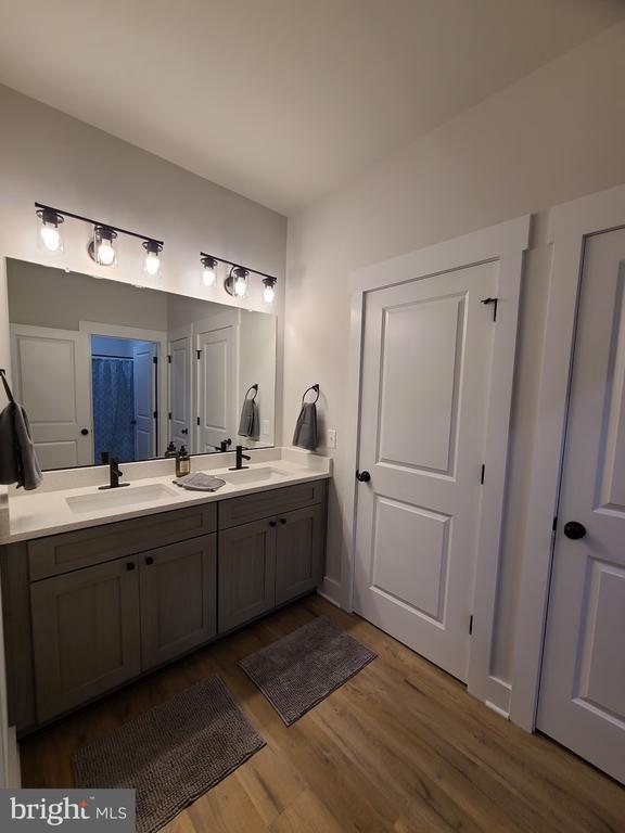 150 Winchester Trl, Mineral, VA 23117 - full bath with double vanity, wood finished floors, and a shower