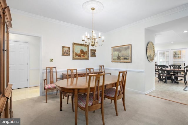 dining room with light carpet, a chandelier, ornamental molding, and baseboards