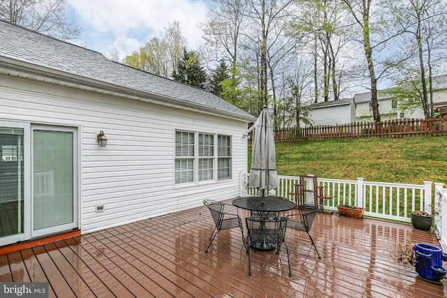 wooden deck featuring outdoor dining area