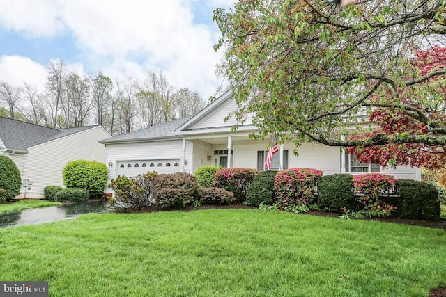 view of front of property with a garage and a front lawn
