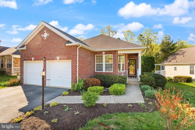  - view of front of house with brick siding, an attached garage, and driveway