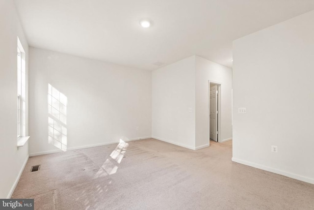  - spare room featuring carpet floors and baseboards