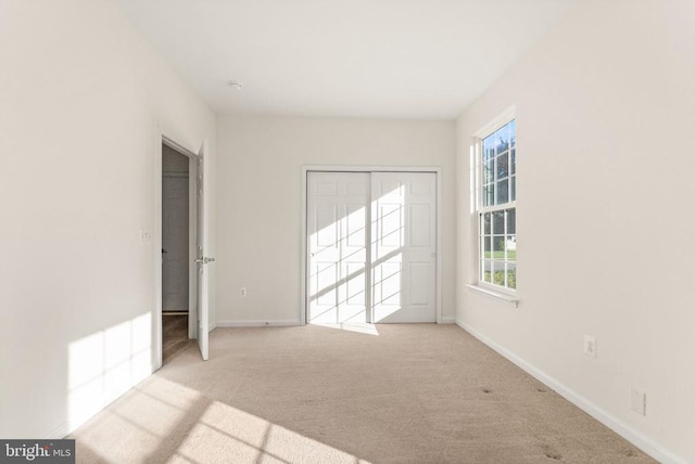  - unfurnished bedroom featuring carpet flooring, baseboards, and a closet