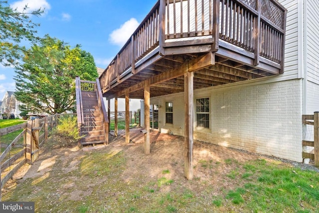  - back of property featuring brick siding, stairway, a wooden deck, and fence