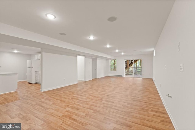  - basement with freestanding refrigerator, light wood finished floors, baseboards, and recessed lighting