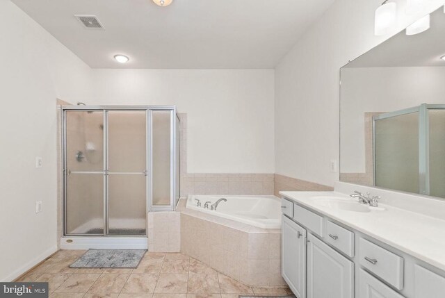  - bathroom featuring a shower stall, a garden tub, vanity, and tile patterned flooring