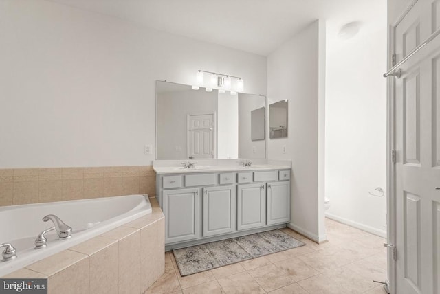  - bathroom with a bath, tile patterned flooring, toilet, and double vanity