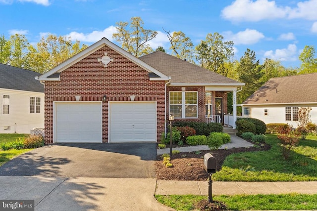 - traditional-style house featuring asphalt driveway, a garage, and brick siding