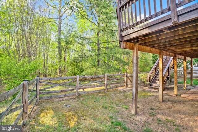  - fenced backyard featuring stairway and a deck
