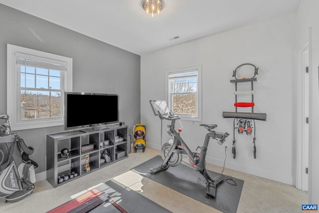 exercise room featuring visible vents, baseboards, and carpet floors