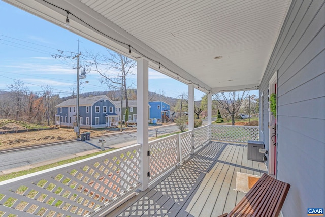 deck with a porch and a residential view