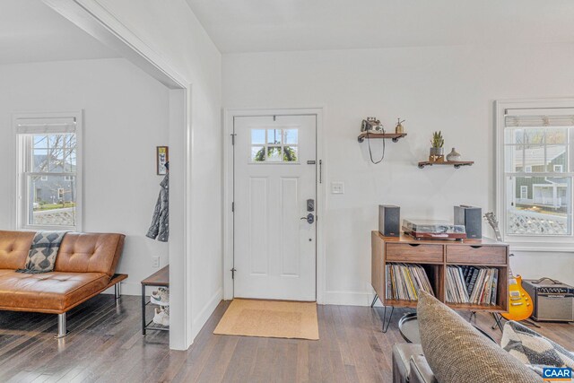 entryway featuring baseboards and wood finished floors
