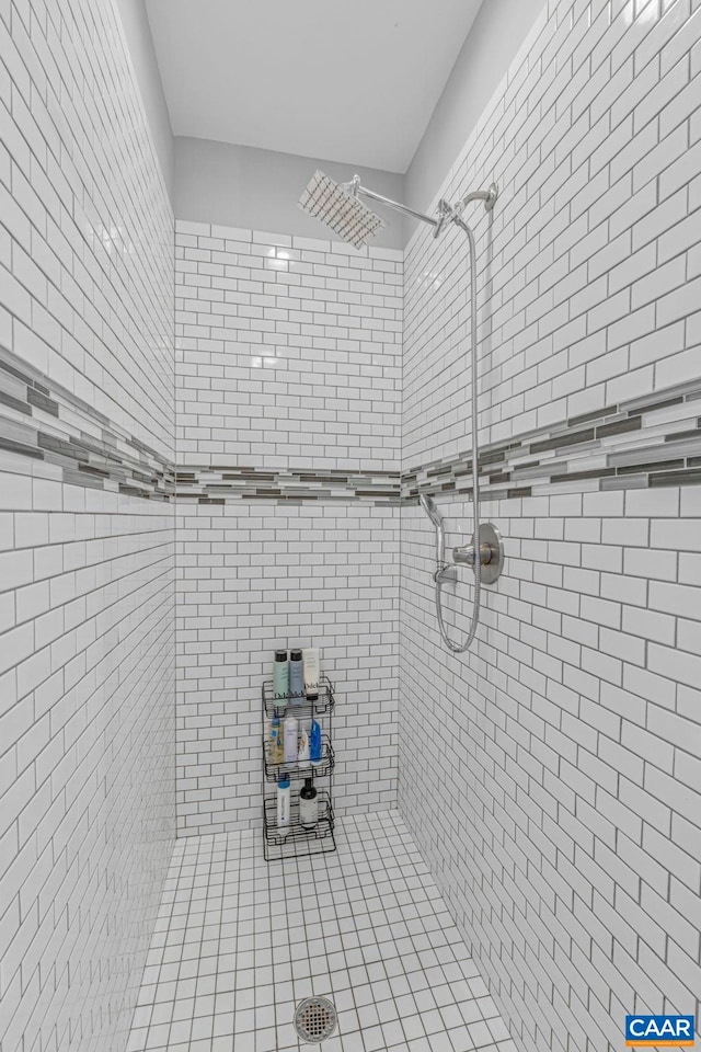 full bath featuring a tile shower