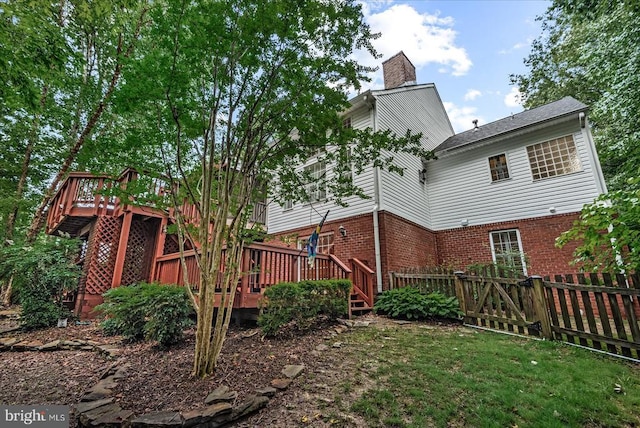 7924 Gold Leaf Cir, Spotsylvania, VA 22551 - back of house featuring a wooden deck, brick siding, and a chimney