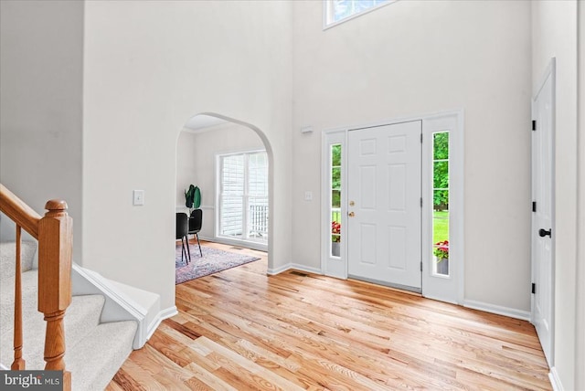 7924 Gold Leaf Cir, Spotsylvania, VA 22551 - entryway featuring plenty of natural light, arched walkways, light wood-style flooring, and a towering ceiling