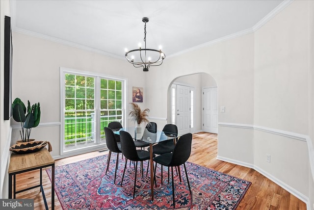 7924 Gold Leaf Cir, Spotsylvania, VA 22551 - dining room featuring arched walkways, a chandelier, healthy amount of natural light, ornamental molding, and wood finished floors