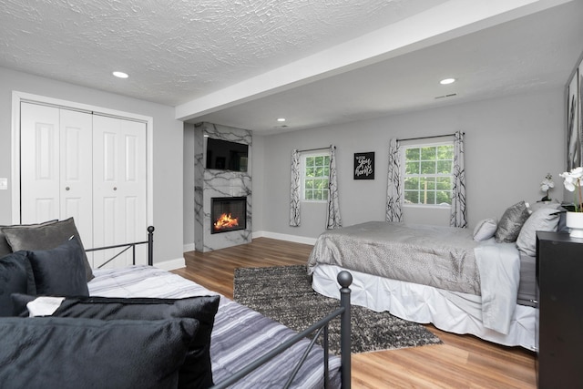 2003 Rinacas Corner Rd, Shenandoah, VA 22849 - bedroom with wood finished floors, a closet, a high end fireplace, recessed lighting, and baseboards