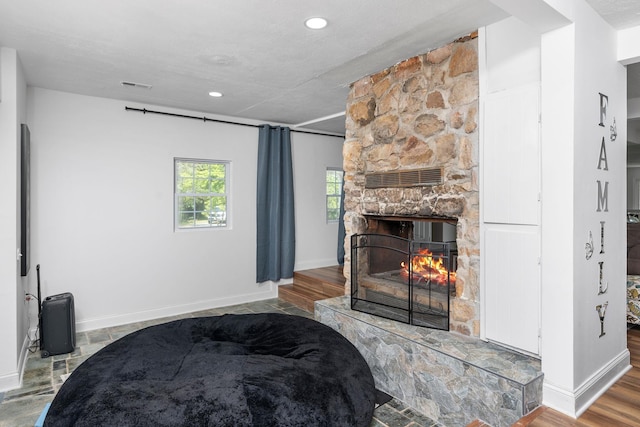 2003 Rinacas Corner Rd, Shenandoah, VA 22849 - living area with a stone fireplace, baseboards, and recessed lighting