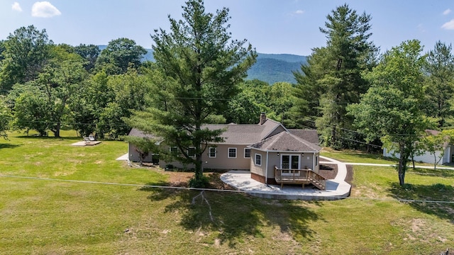 2003 Rinacas Corner Rd, Shenandoah, VA 22849 - back of property with a wooden deck, a lawn, and a chimney