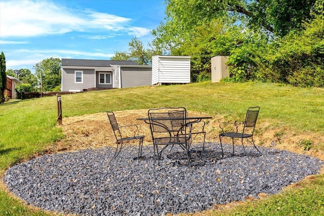 view of grassy yard with an outdoor structure and a shed