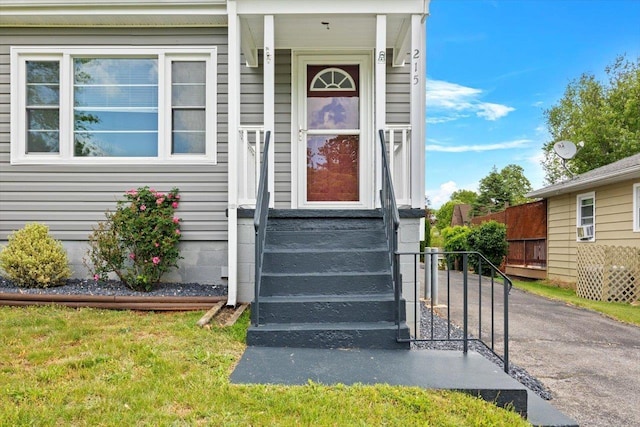view of exterior entry with fence