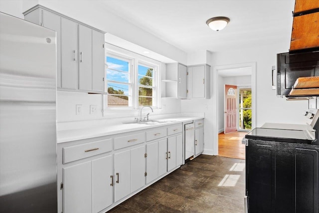 kitchen with range with electric cooktop, refrigerator, a sink, light countertops, and open shelves