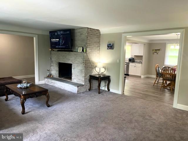 12134 Baylor Ln, Orange, VA 22960 - living room featuring a fireplace and carpet flooring