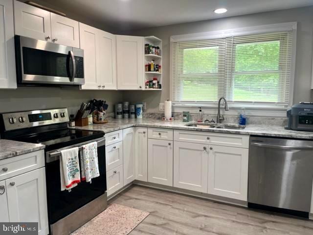 12134 Baylor Ln, Orange, VA 22960 - kitchen with stainless steel appliances, white cabinets, light stone counters, and recessed lighting