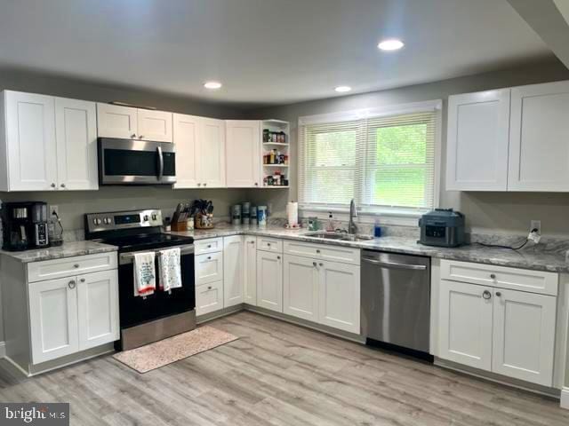 12134 Baylor Ln, Orange, VA 22960 - kitchen featuring stainless steel appliances, white cabinets, recessed lighting, and light wood-type flooring