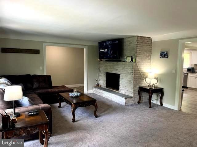 12134 Baylor Ln, Orange, VA 22960 - living room featuring a brick fireplace and carpet