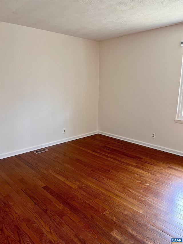 4646 Woods Edge Rd, Troy, VA 22974 - empty room with dark wood-type flooring, baseboards, and a textured ceiling