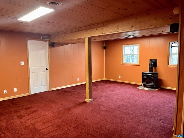4646 Woods Edge Rd, Troy, VA 22974 - basement with a wood stove, wooden ceiling, dark carpet, and baseboards