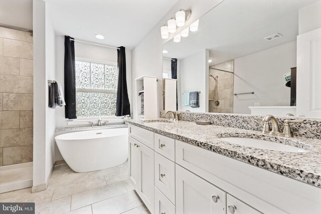 12929 Pipe Run Dr, Fredericksburg, VA 22407 - bathroom featuring a tile shower, double vanity, a freestanding tub, and recessed lighting