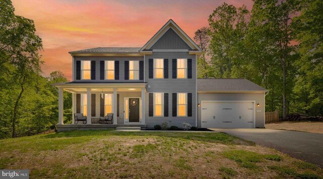 12929 Pipe Run Dr, Fredericksburg, VA 22407 - view of front facade with asphalt driveway, a porch, a garage, and a lawn