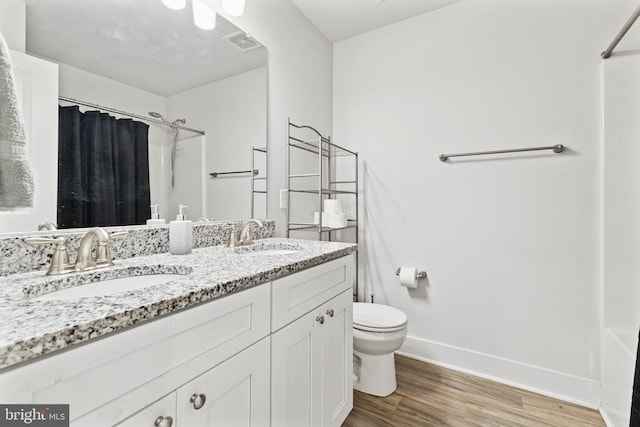 12929 Pipe Run Dr, Fredericksburg, VA 22407 - bathroom featuring toilet, a shower with curtain, baseboards, double vanity, and wood finished floors