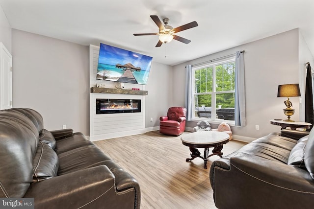 12929 Pipe Run Dr, Fredericksburg, VA 22407 - living room with wood finished floors, a glass covered fireplace, baseboards, and ceiling fan