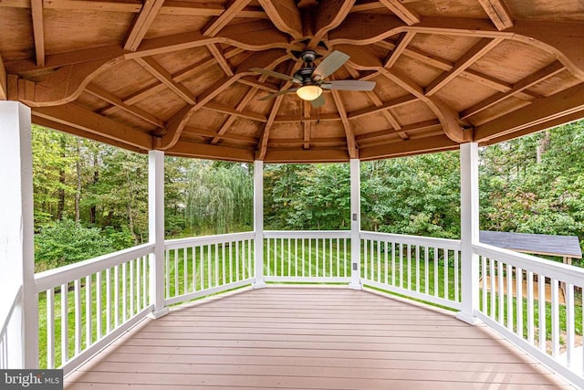deck with a gazebo, a yard, and a ceiling fan