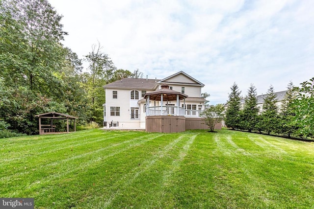 rear view of house with a gazebo and a yard
