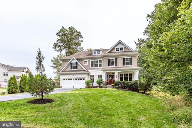shingle-style home with driveway and a garage