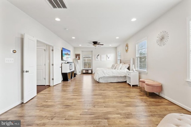 bedroom with light wood-type flooring, recessed lighting, a ceiling fan, and baseboards