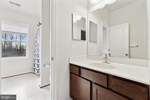 bathroom with vanity and baseboards