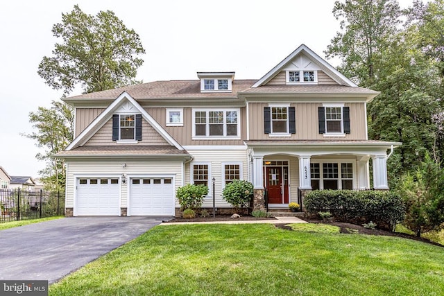 view of front of home featuring asphalt driveway, a garage, and board and batten siding