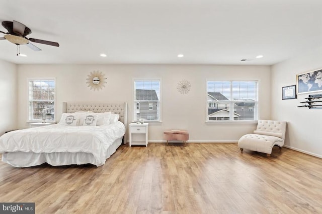 bedroom featuring wood finished floors, recessed lighting, and baseboards