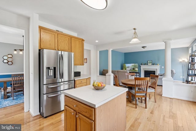 12314 Osprey Ln, Culpeper, VA 22701 - kitchen with stainless steel refrigerator with ice dispenser, decorative columns, light wood finished floors, light countertops, and a kitchen island